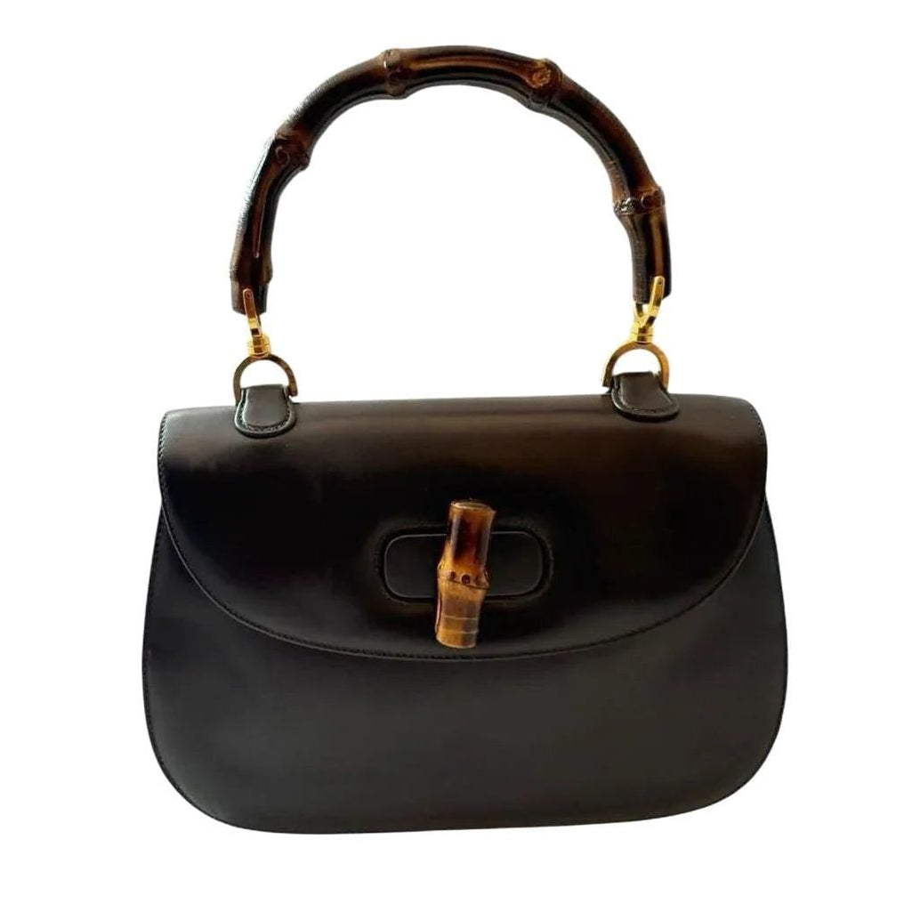 Gucci black handbag with bamboo handle and gold-tone hardware, smooth leather finish.