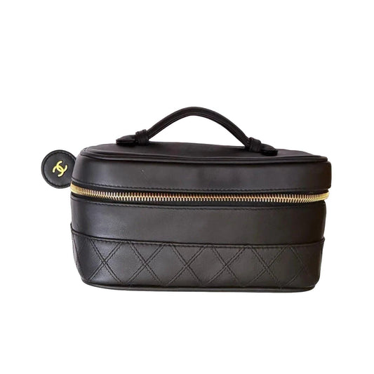 Chanel black bicolore vanity case with gold-tone hardware and iconic stitching details.