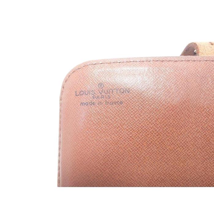 Louis Vuitton brown crossbody bag with iconic monogram canvas and aged leather trim.