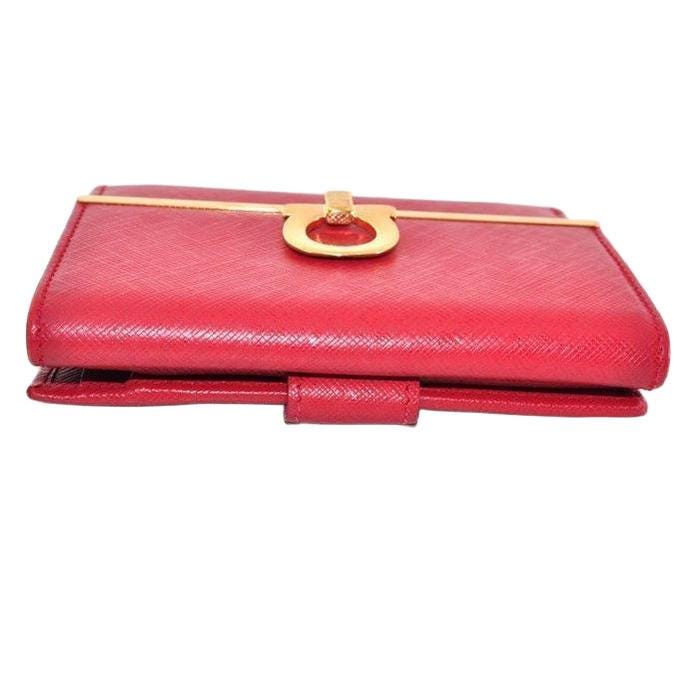 Salvatore Ferragamo red leather wallet with gold hardware and organized interior.