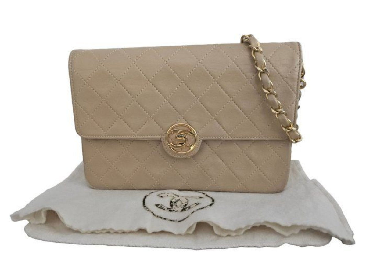 Chanel beige quilted leather flap bag with gold hardware and interlocking CC turn-lock.