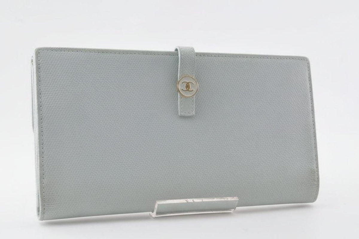 Chanel blue leather wallet with logo detail and minimalist design, featuring light scuffs.