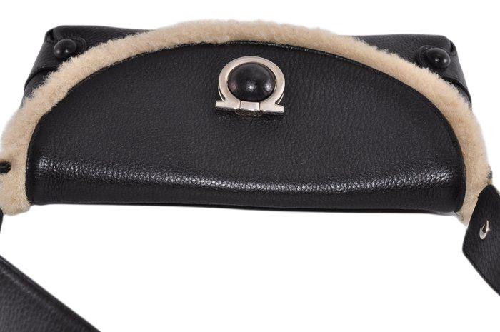 Salvatore Ferragamo black leather purse with shearling trim and Gancini hardware.