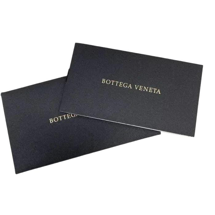 Bottega Veneta brown leather pouch with intrecciato weave and zip-around closure.