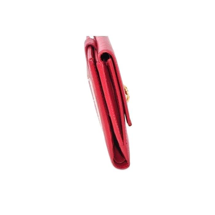 Salvatore Ferragamo red leather wallet with gold hardware and organized interior.