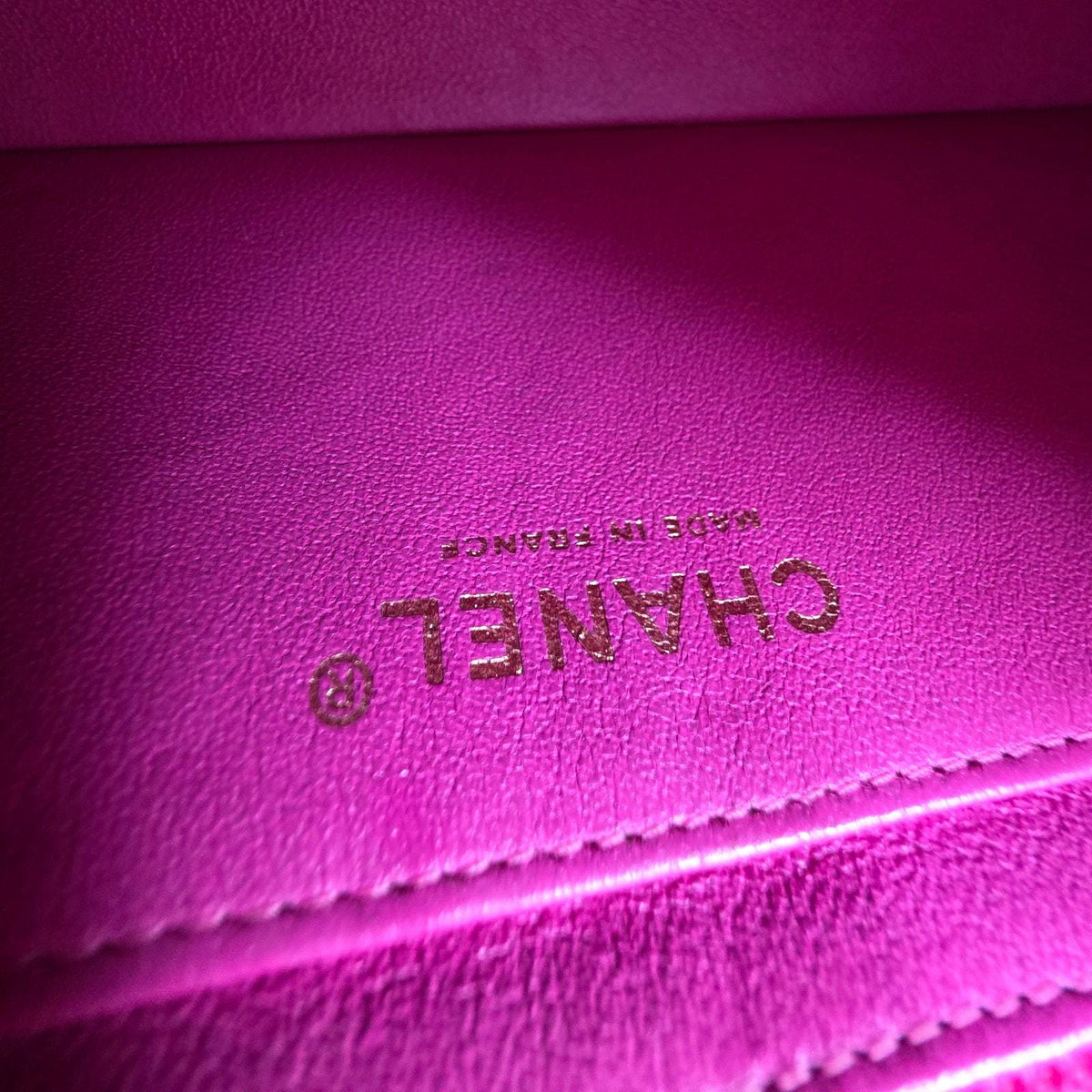 Chanel pink mini messenger bag in chevron leather with gold CC clasp and hardware.