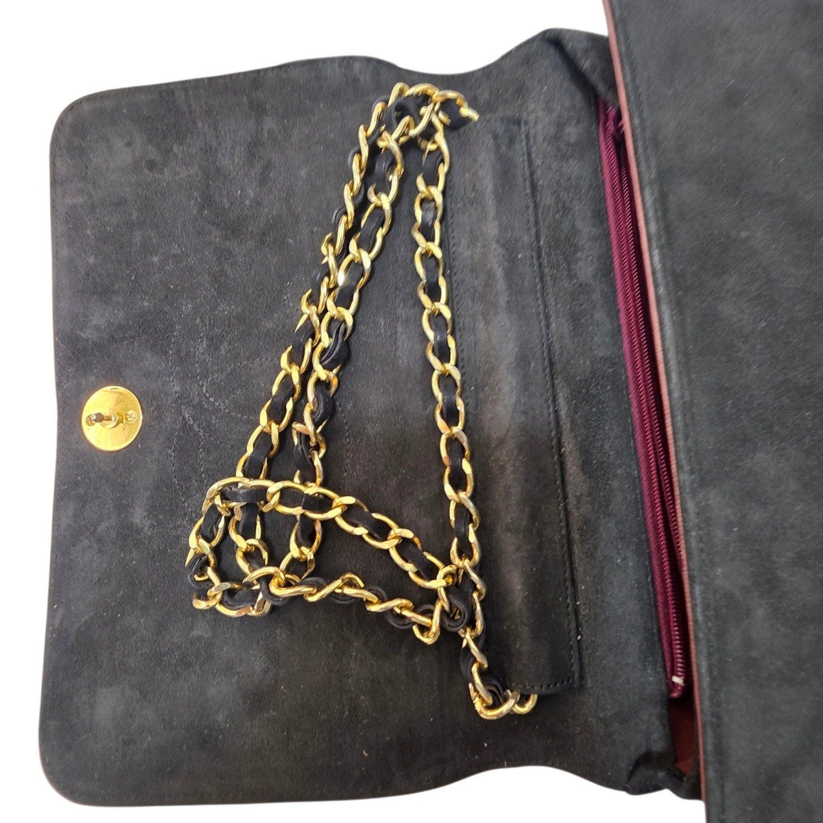 Chanel black quilted suede crossbody bag with gold chain and leather woven strap.