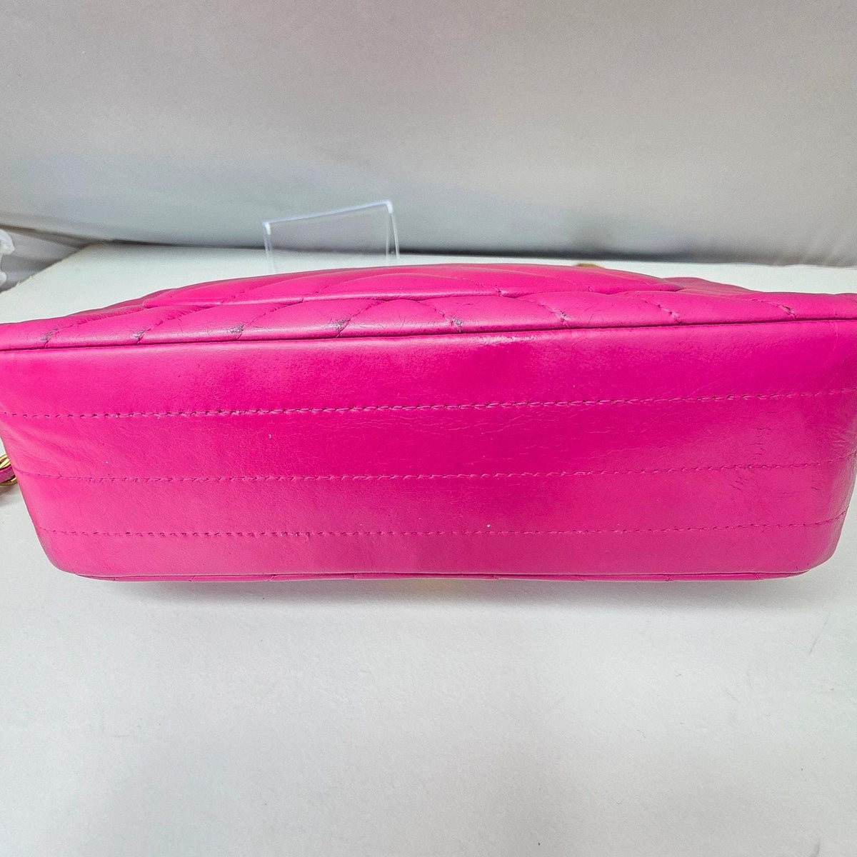 Chanel pink mini messenger bag in chevron leather with gold CC clasp and hardware.