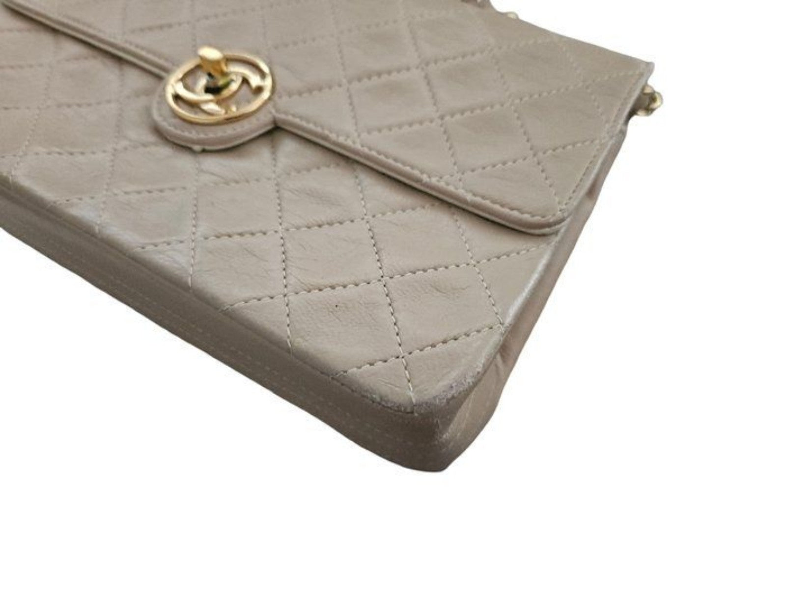 Chanel beige quilted leather flap bag with gold hardware and interlocking CC turn-lock.