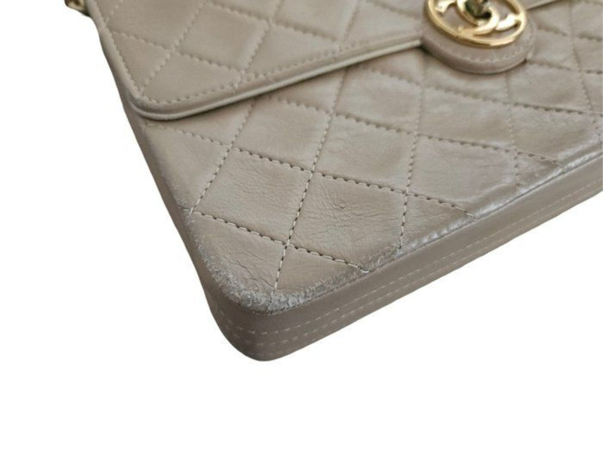 Chanel beige quilted leather flap bag with gold hardware and interlocking CC turn-lock closure.