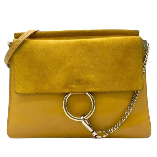 Chloè yellow messenger bag with gold-tone ring, suede and leather textures.