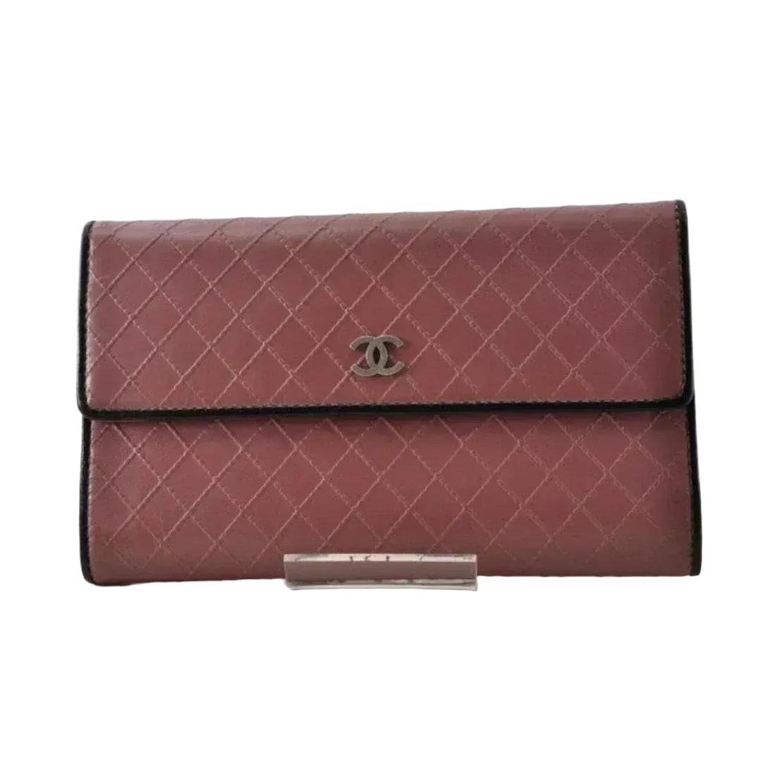 Chanel bifold wallet bordeaux leather with embossed logo and sleek design.
