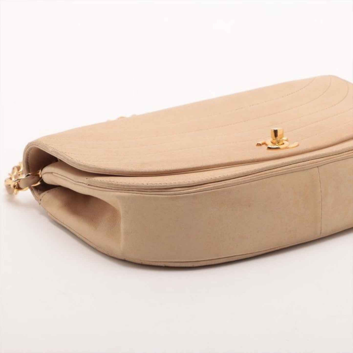 CHANEL beige matelassé leather half moon shoulder bag with gold hardware and classic logo.