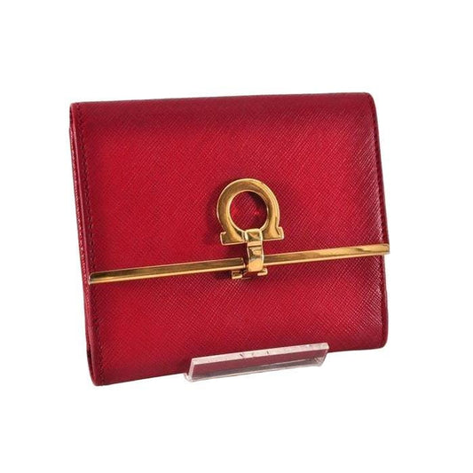 Salvatore Ferragamo red leather wallet with gold hardware and organized interior.