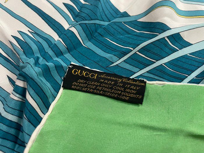 Gucci silk scarf multi-colour floral pattern with iconic logo and vintage charm.