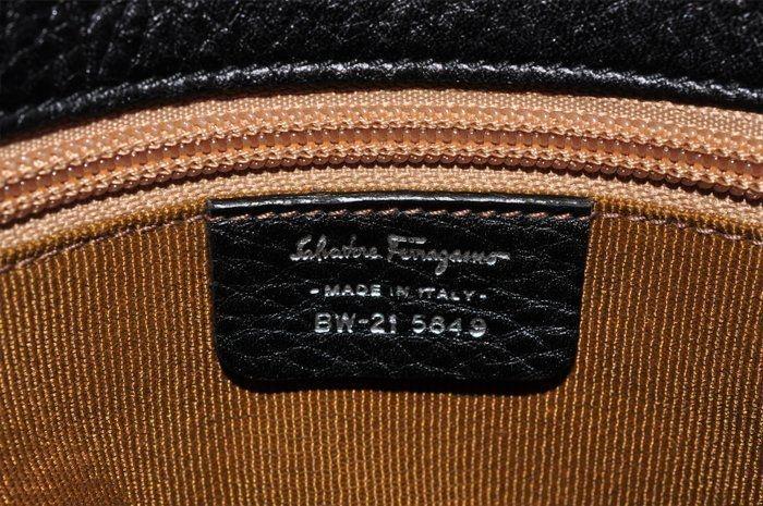 Salvatore Ferragamo black leather purse with shearling trim and Gancini hardware.