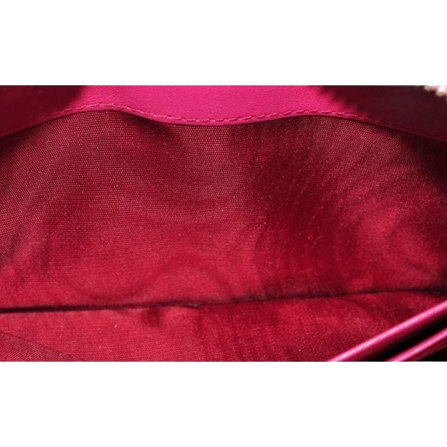 Prada pink nylon and leather zip-around wallet with minimalist design and secure closure.