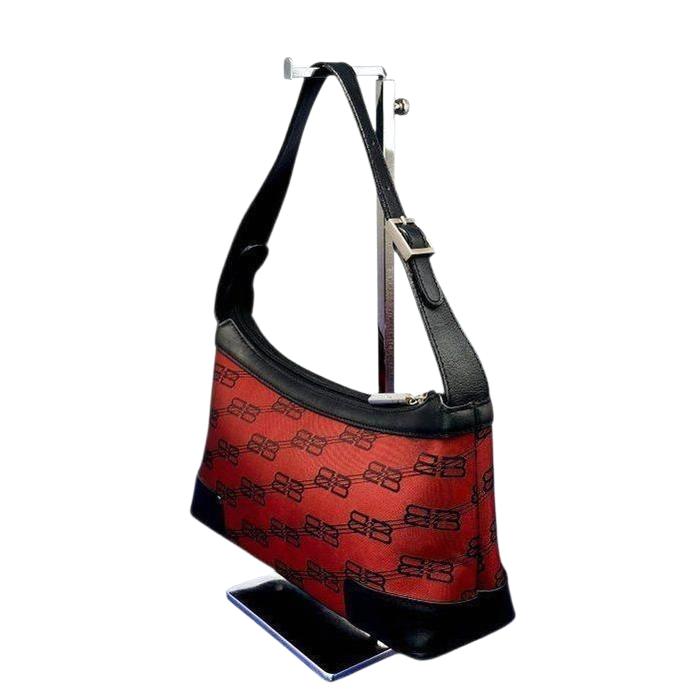 Balenciaga black and red shoulder bag with signature monogram and adjustable strap.