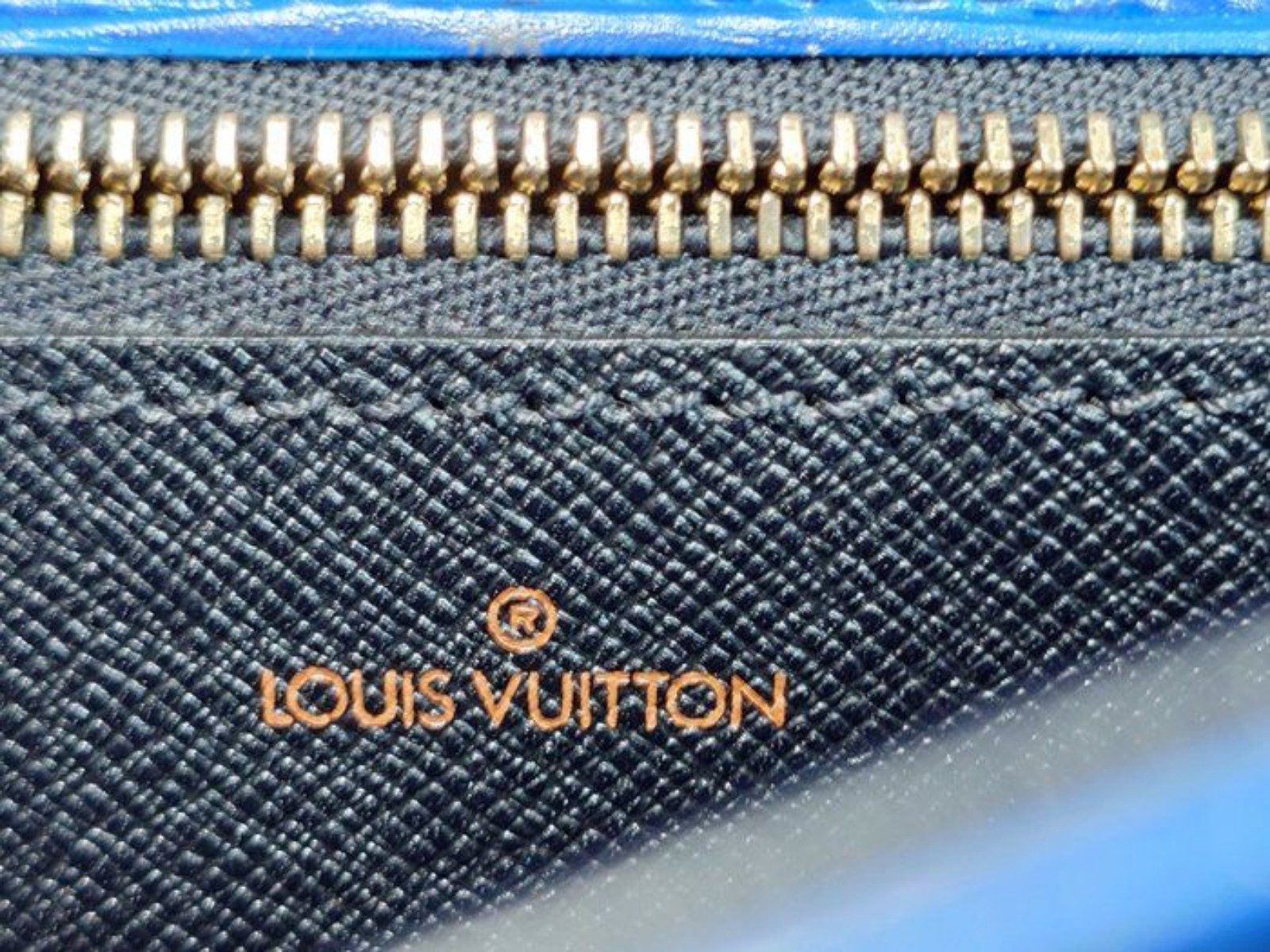 Louis Vuitton blue Epi leather crossbody bag with signature LV logo and brass hardware.