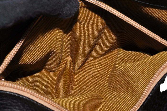 Salvatore Ferragamo black leather purse with shearling trim and Gancini hardware.