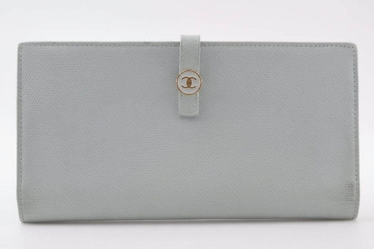 Chanel blue leather wallet with logo detail and minimalist design, featuring light scuffs.