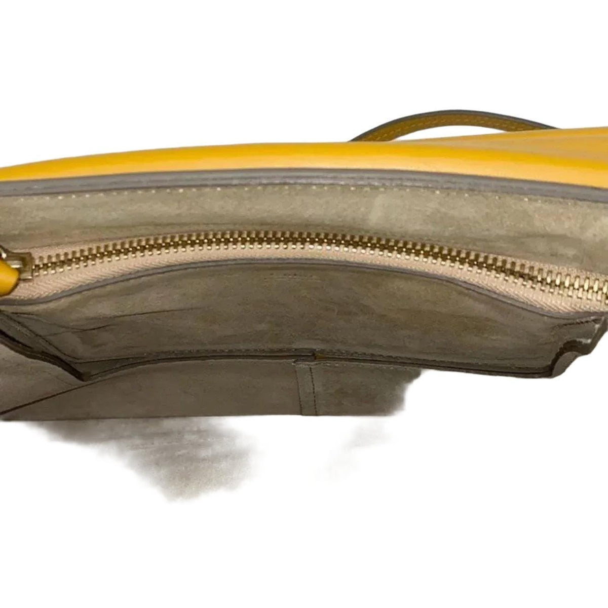 Chloè yellow messenger bag with gold-tone ring, suede and leather textures.