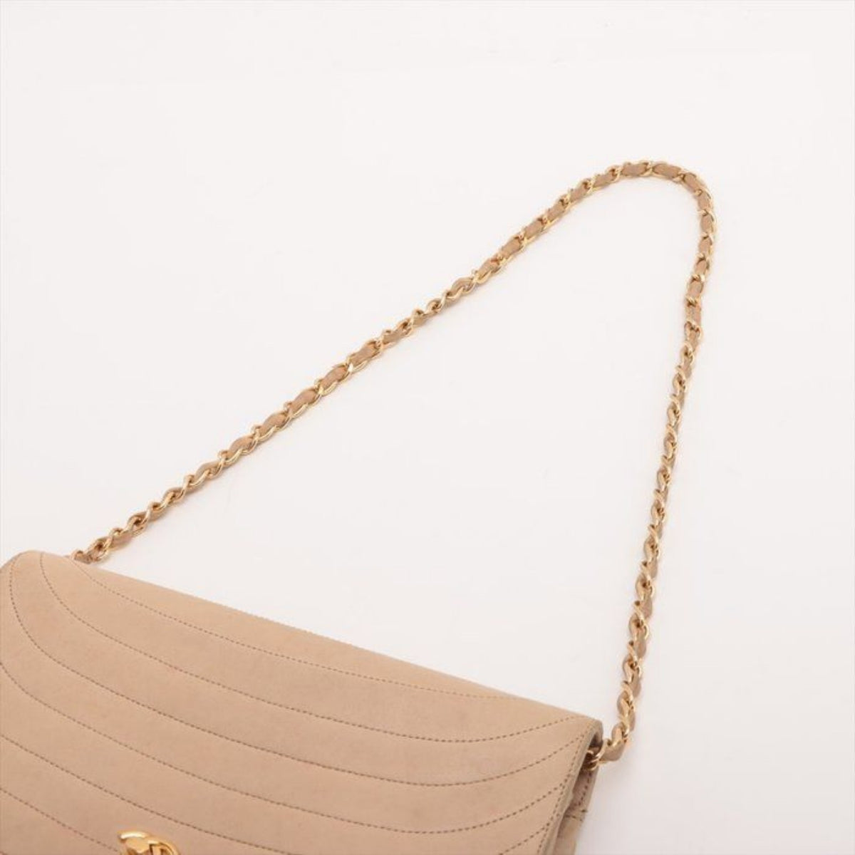 CHANEL beige matelassé leather half moon shoulder bag with gold hardware and classic logo.