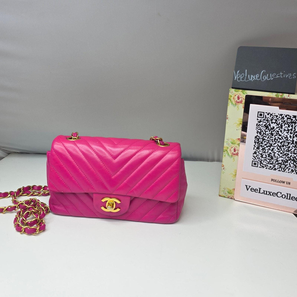 Chanel pink mini messenger bag in chevron leather with gold CC clasp and hardware.