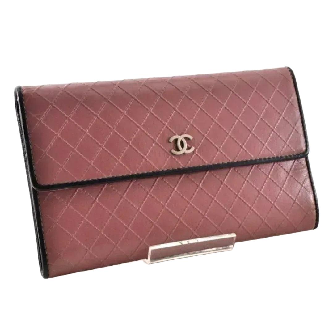 Chanel bifold wallet bordeaux leather with embossed logo and sleek design.