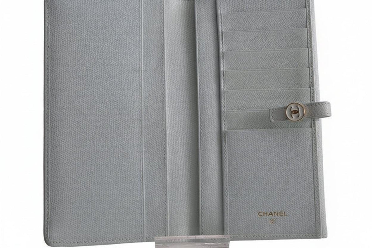 Chanel blue leather wallet with logo detail and minimalist design, featuring light scuffs.