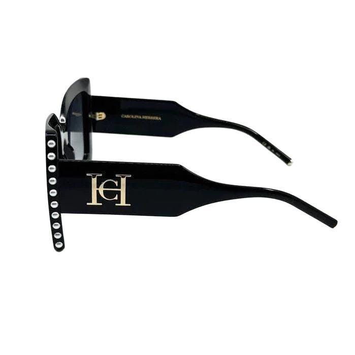 Carolina Herrera black acetate sunglasses with grey lenses and signature logo detailing.