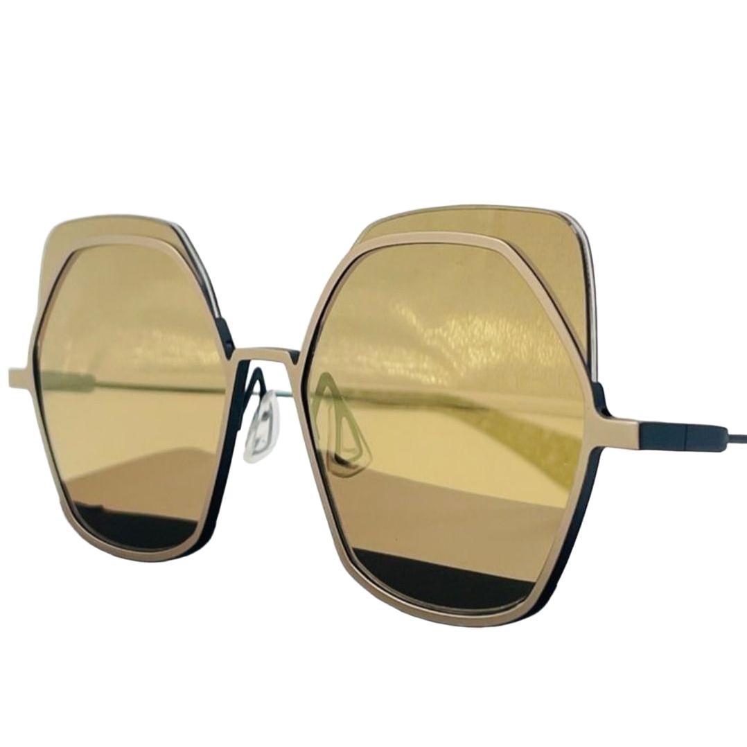 Yohji Yamamoto gold sunglasses with bronze finish and original pouch, sleek metal design.