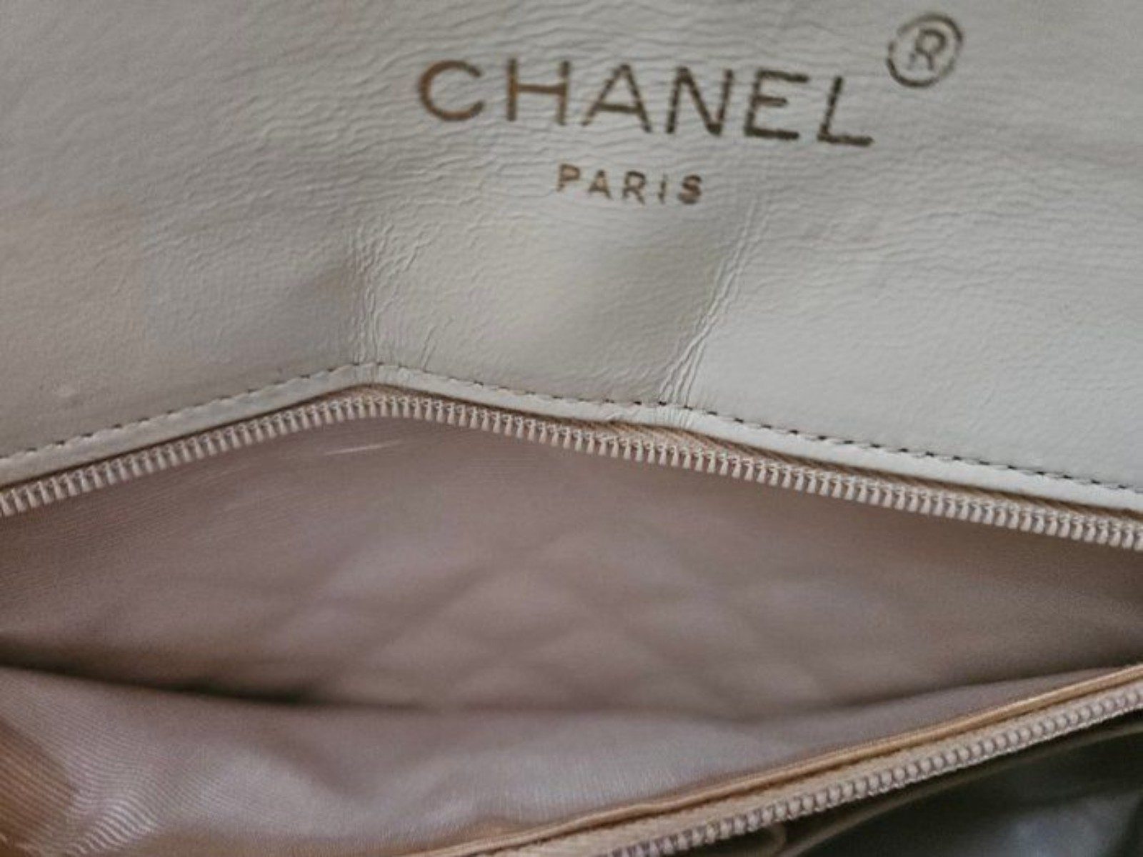 Chanel beige quilted leather flap bag with gold hardware and interlocking CC turn-lock.