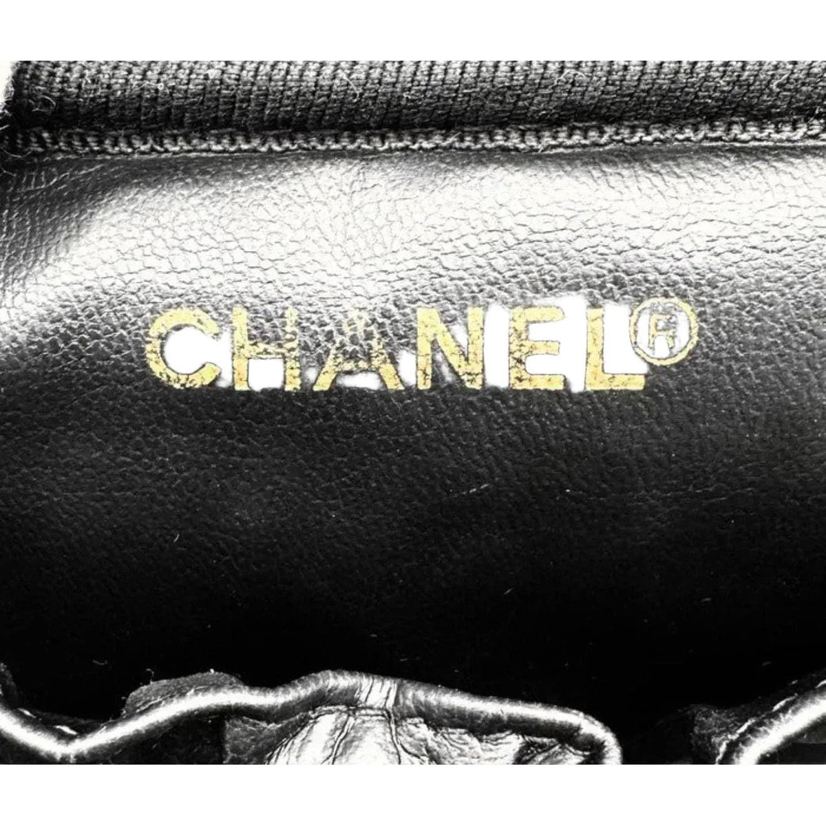 Chanel black bicolore vanity case with gold-tone hardware and iconic stitching details.