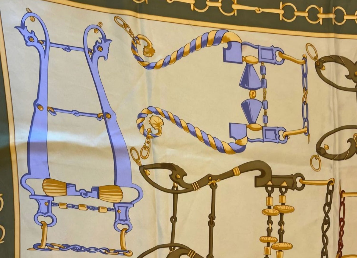 Gucci silk scarf featuring vintage equestrian print in gold, green, and yellow.