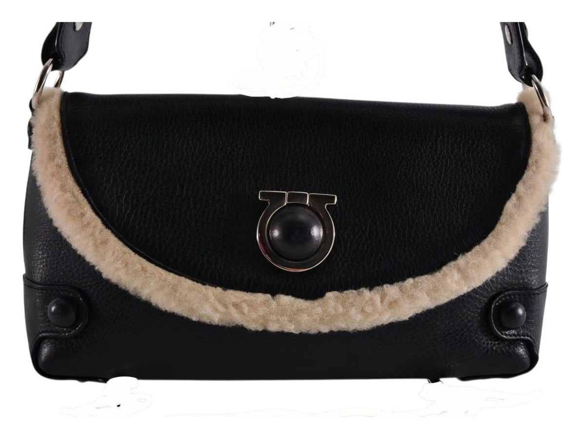 Salvatore Ferragamo black leather purse with shearling trim and Gancini hardware.