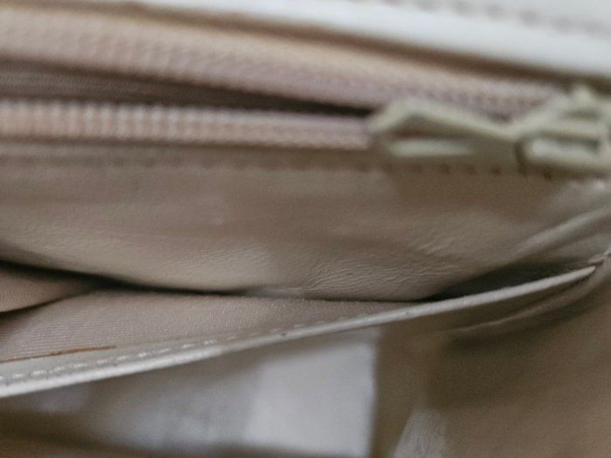Chanel beige quilted leather flap bag with gold hardware and interlocking CC turn-lock.