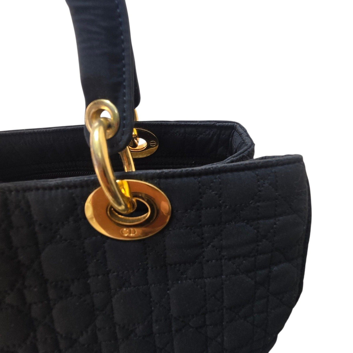 Christian Dior black quilted nylon tote bag with gold hardware and leather trim.