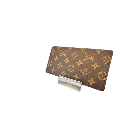 Louis Vuitton brown bifold wallet featuring iconic monogram pattern and coated canvas material.