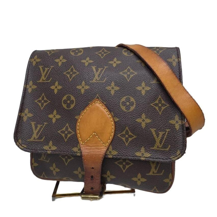 Louis Vuitton brown crossbody bag with iconic monogram canvas and aged leather trim.