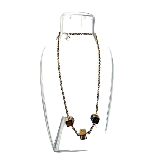 Louis Vuitton gold necklace with monogram dice charms and sparkling crystals.