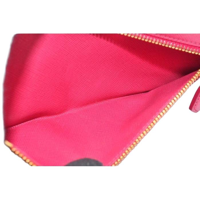Prada pink leather wallet with logo detail and slim design, perfect for essentials.