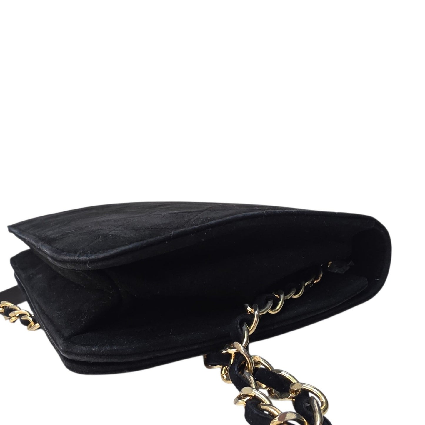 Chanel black quilted suede crossbody bag with gold chain and leather woven strap.