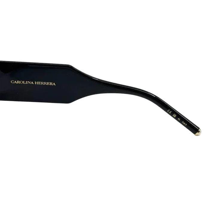 Carolina Herrera black acetate sunglasses with grey lenses and signature logo detailing.