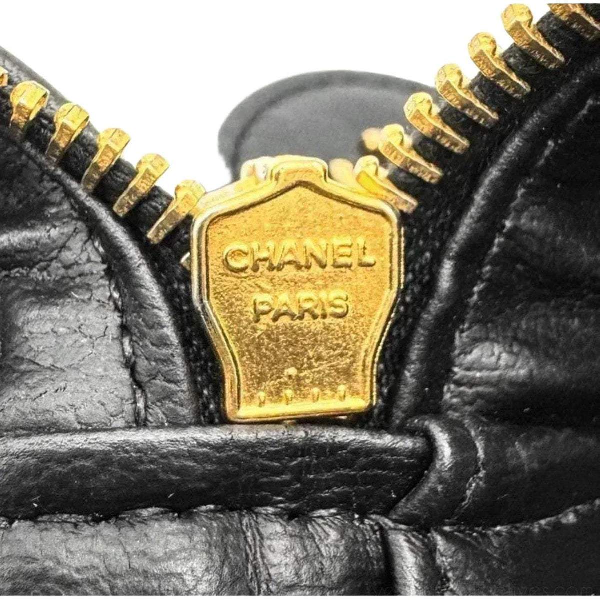 Chanel black bicolore vanity case with gold-tone hardware and iconic stitching details.