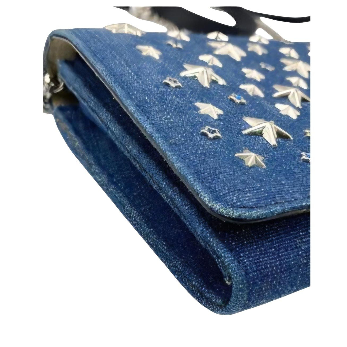 Jimmy Choo blue denim crossbody bag with silver star studs and chain-link strap.
