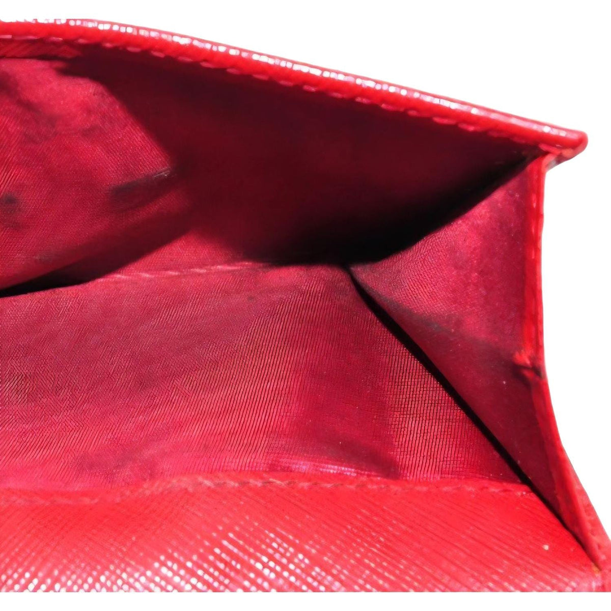 Salvatore Ferragamo red leather wallet with gold hardware and organized interior.