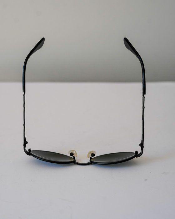 Fendi black and gold sunglasses with logo detail, high-quality plastic and metal frame.