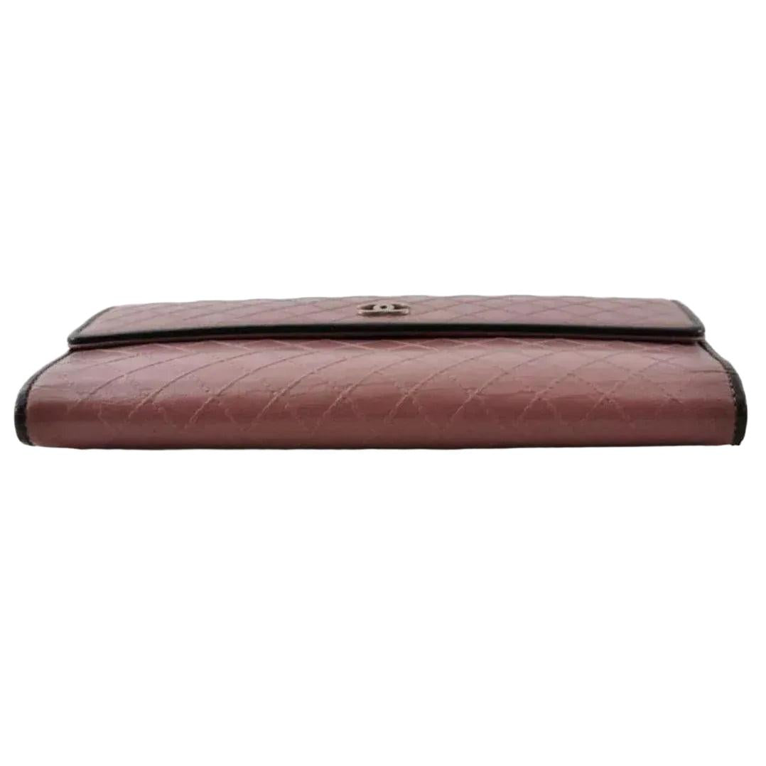 Chanel bifold wallet bordeaux leather with embossed logo and sleek design.