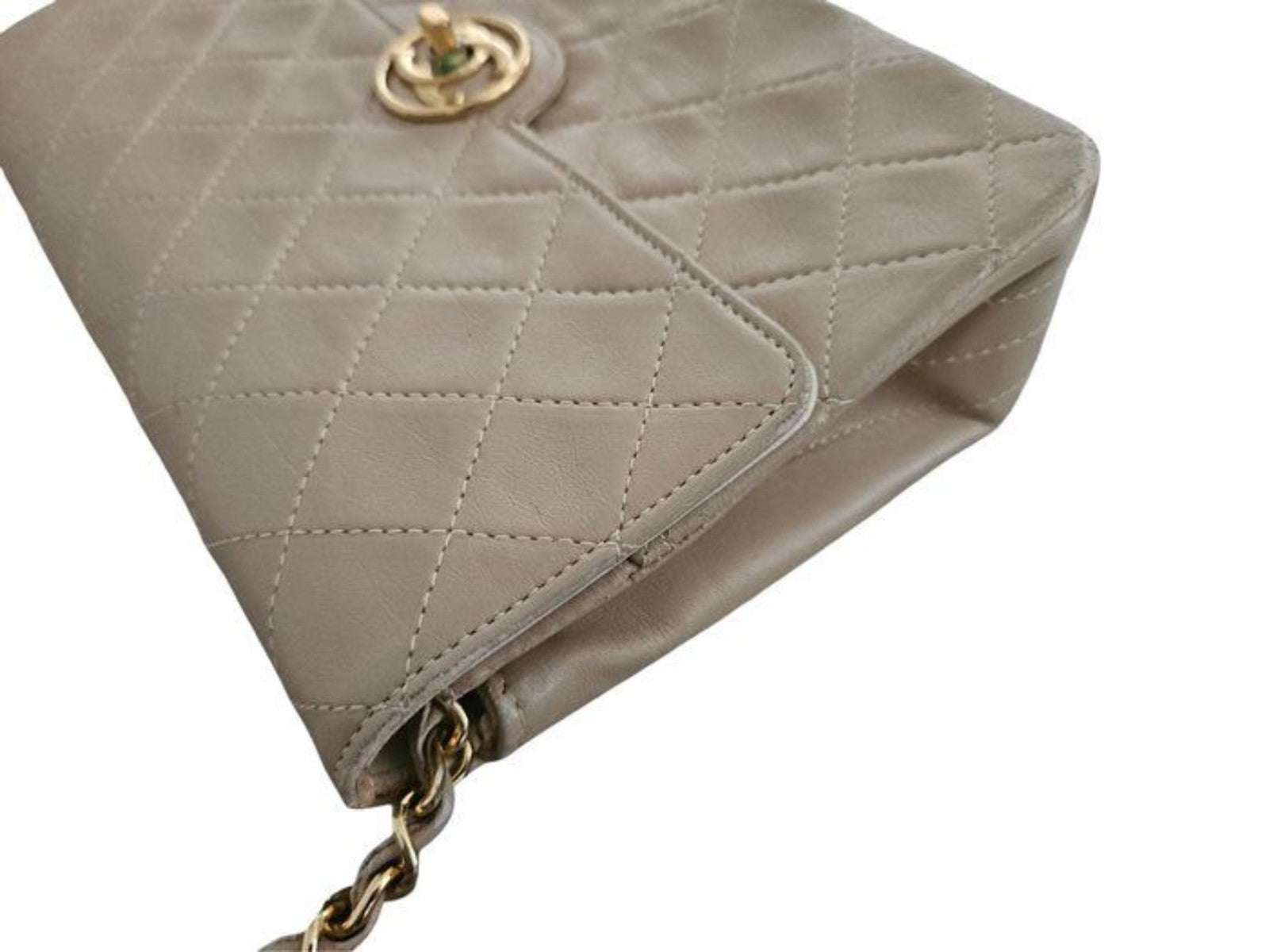 Chanel beige quilted leather flap bag with gold hardware and interlocking CC turn-lock.